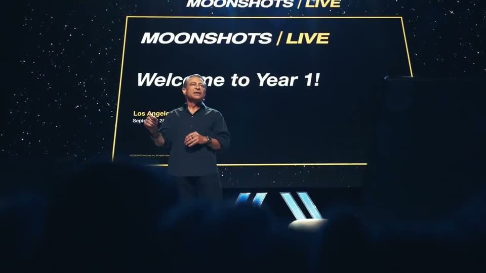 Peter Diamandis on stage under the words Welcome to Year 1
